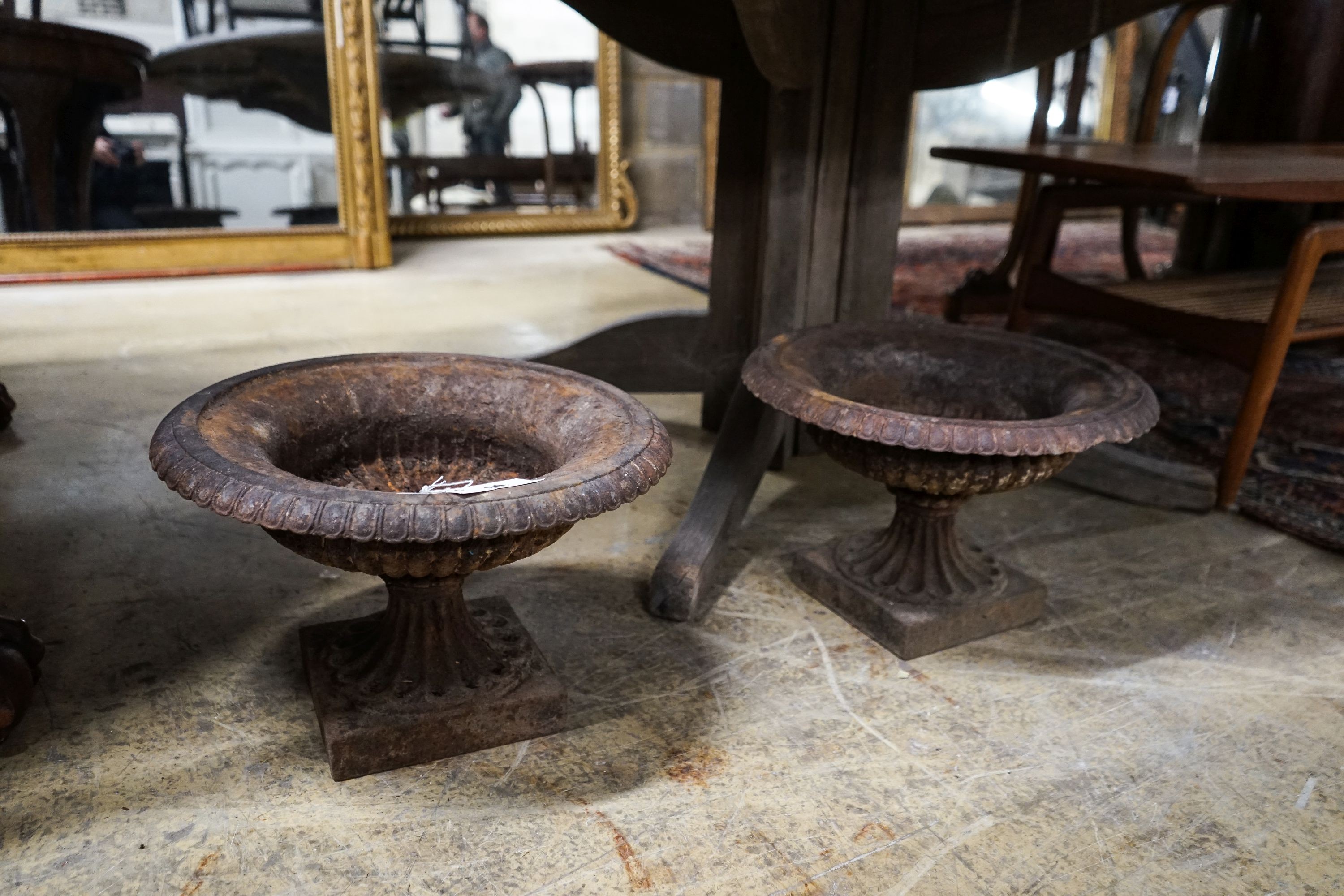 A pair of Victorian cast iron campana garden urns, diameter 38cm, height 25cm